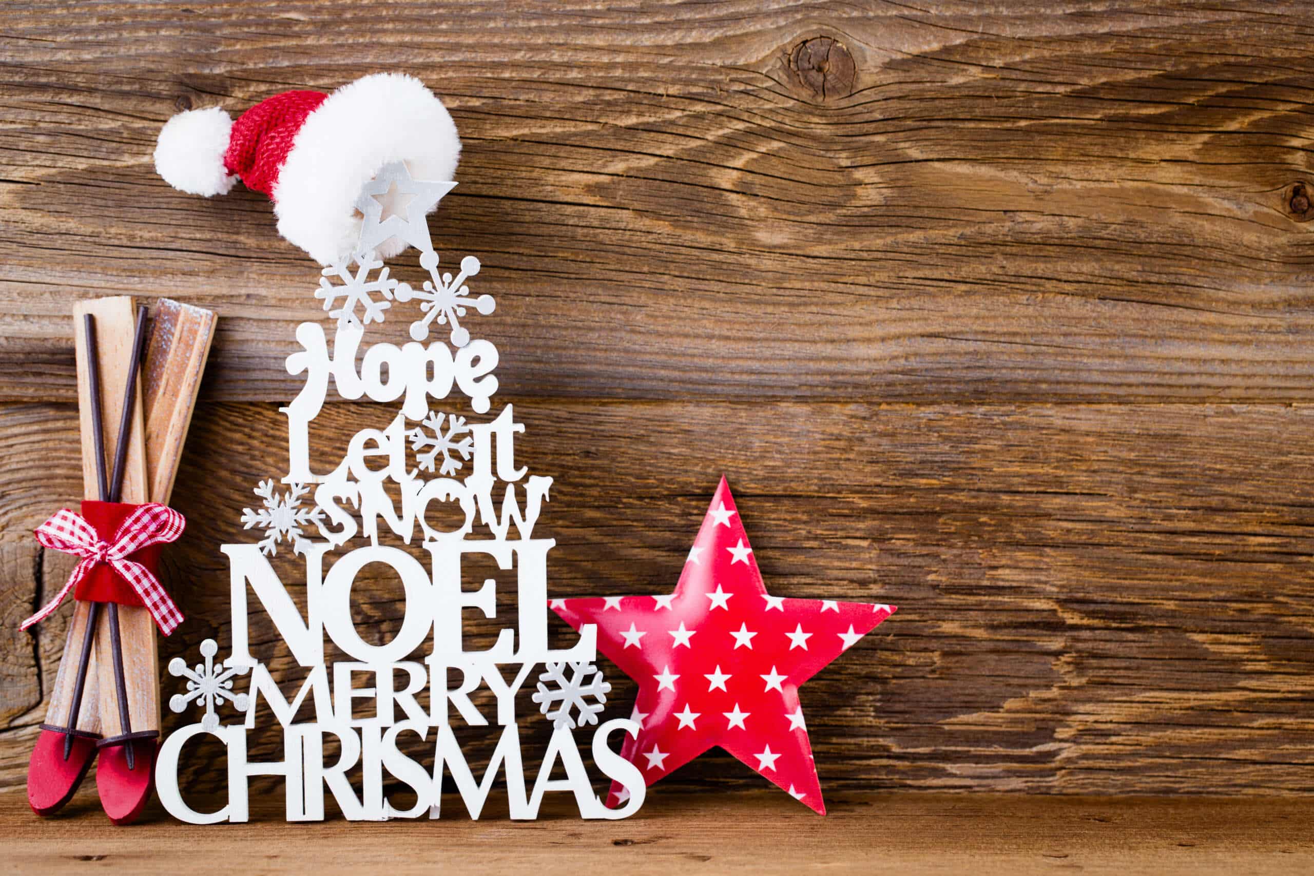 decorated Christmas quotes against a wooden backgorund