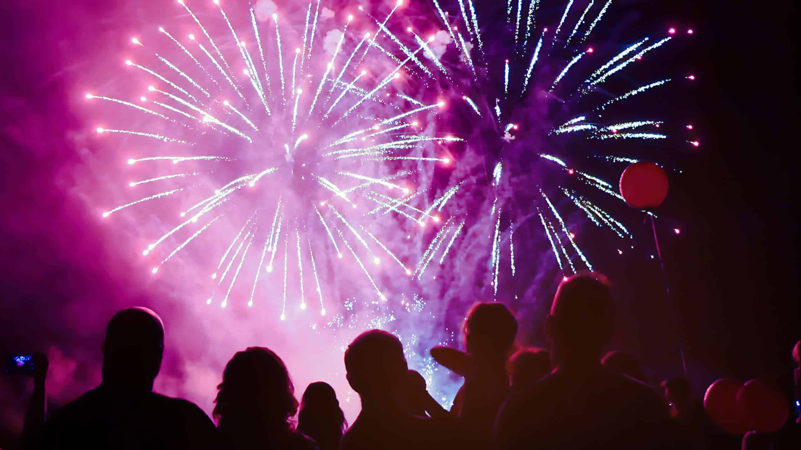 a crowd watching fireworks as part of sober New Year's ideas