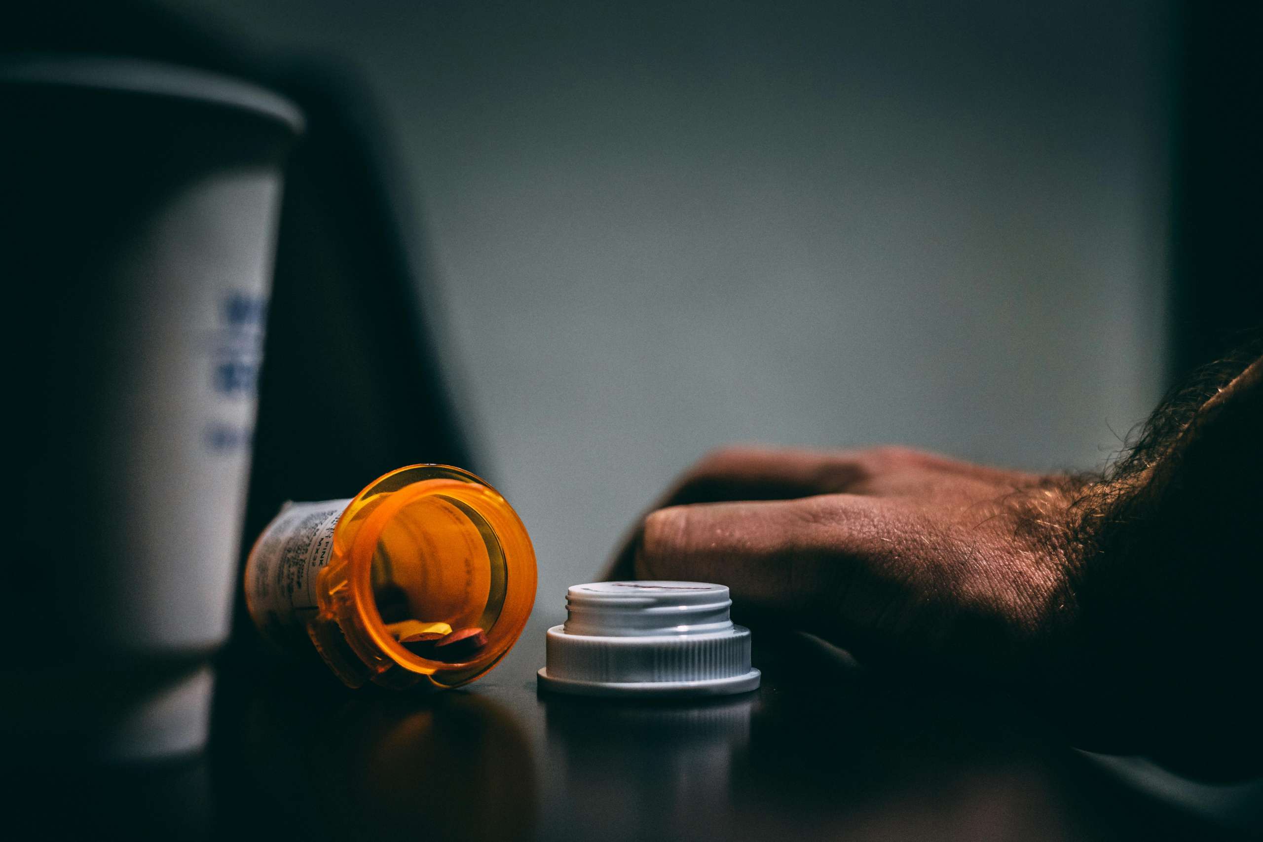 A bottle of Xanax spilled over indicating Xanax overuse.